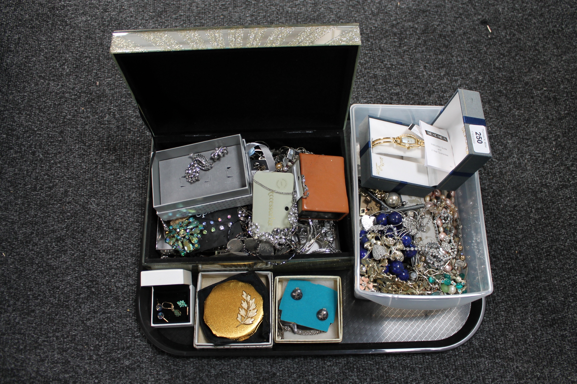 A tray of silver and costume jewellery, wristwatch,