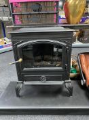 A cast iron Durley log effect electric fire with black marble hearth