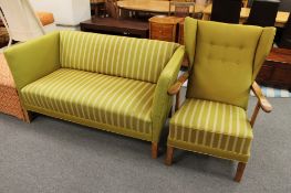 An oak framed wing backed armchair and matching two seater settee