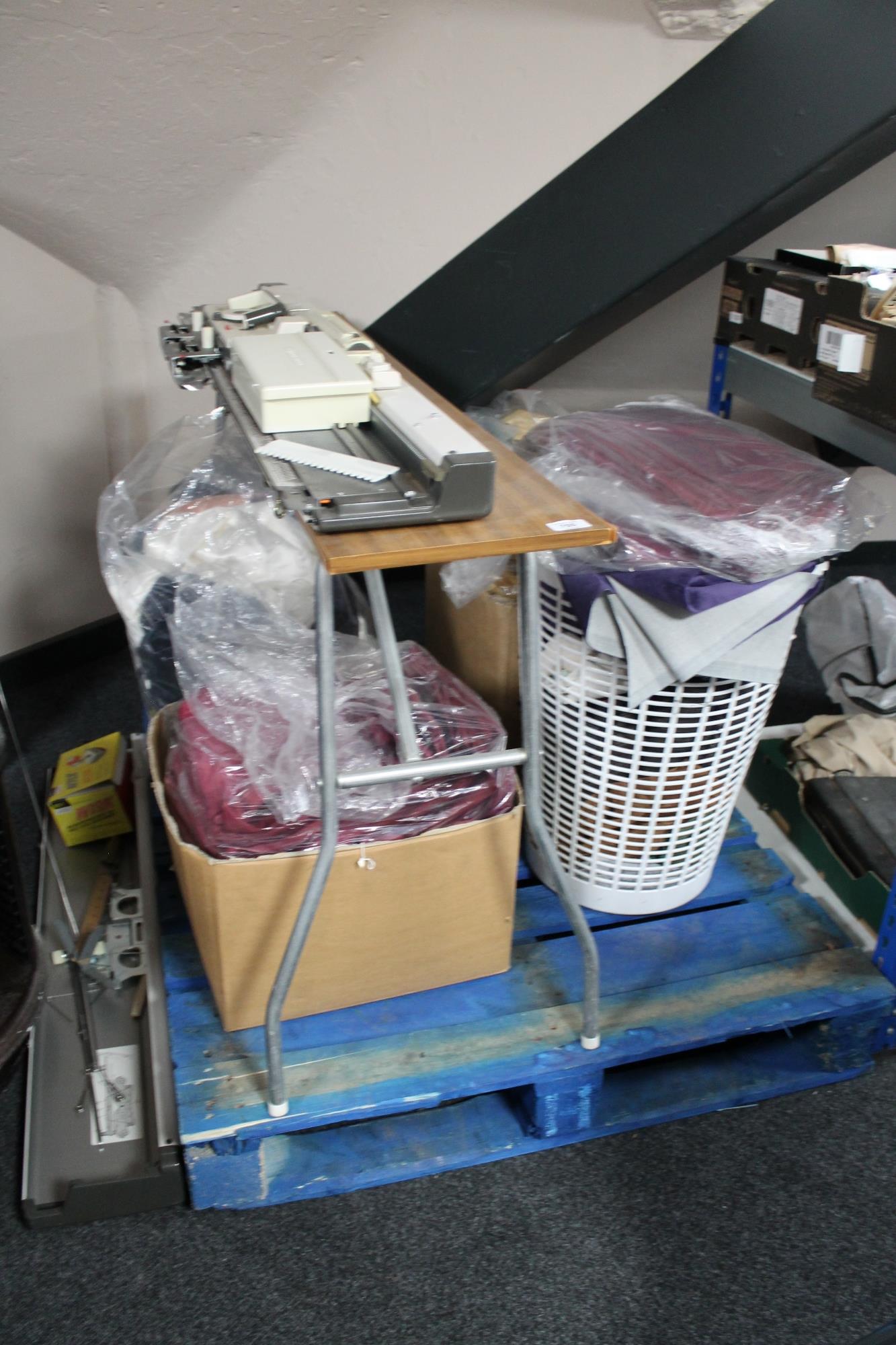 A knitting machine on stand with a quantity of material