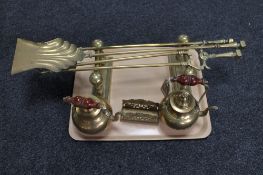 A tray of brass fire dogs, brass companion set,