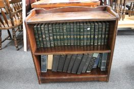 A set of mahogany open bookshelves containing a set of twenty-one Harvard Classics volumes,