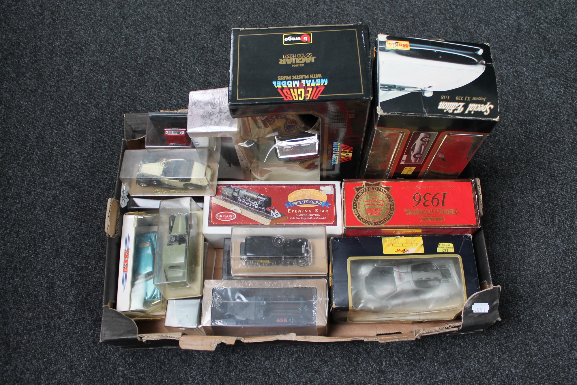 A tray of boxed die cast vehicles including Burago Jaguar, Maisto McLaren F1,