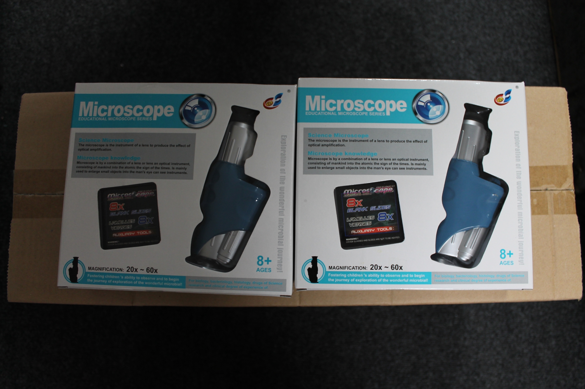 Twenty boxed educational microscopes