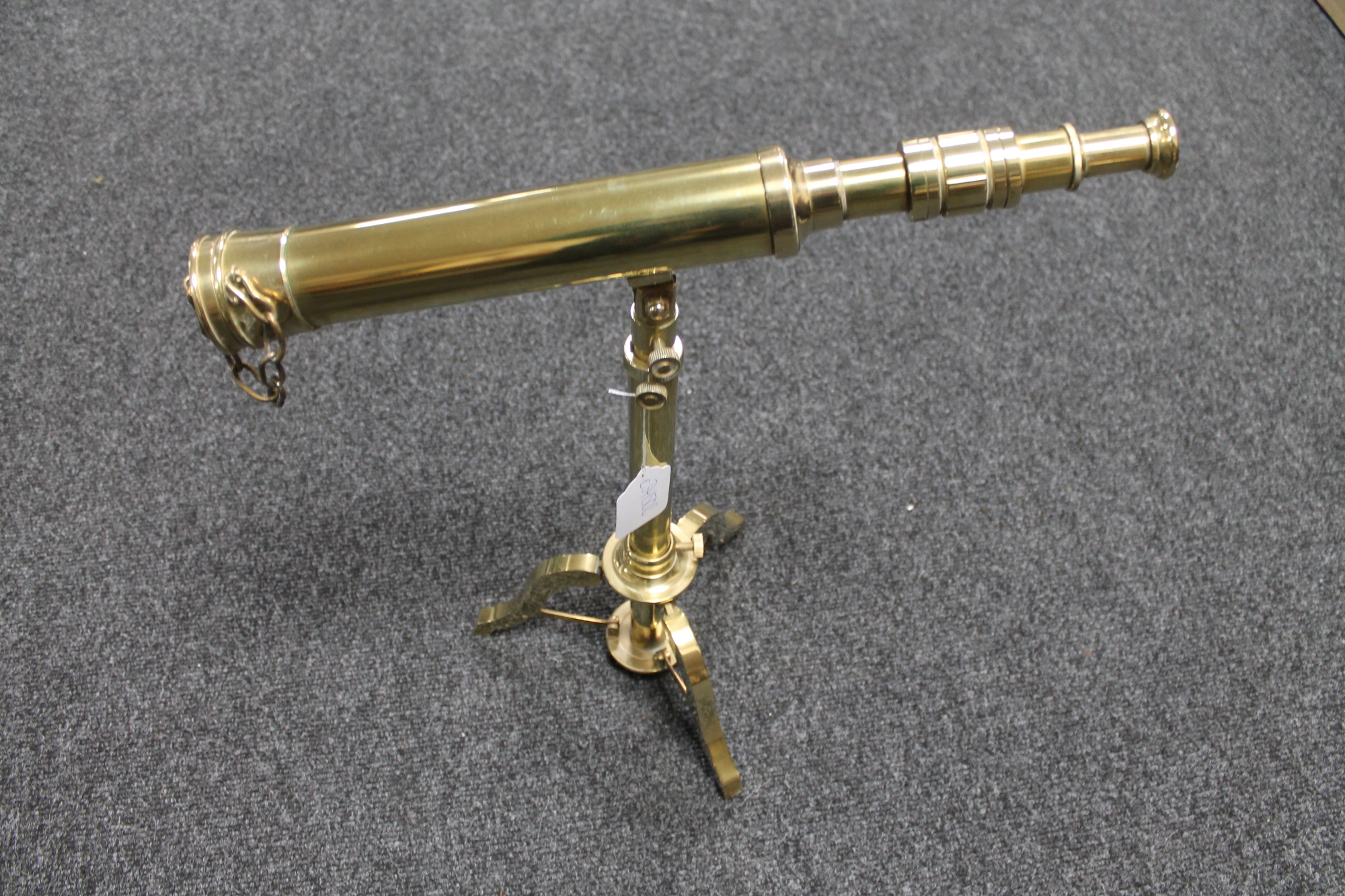 A brass tripod telescope stamped Ross London