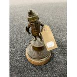 An antique bronze figure of a leprechaun on wooden base,