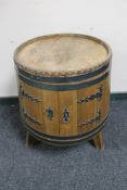 An oak coopered barrel cabinet on legs