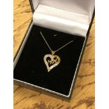 A gold diamond set 'Mom' pendant on chain