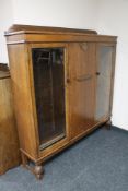 A 1930's oak triple door bookcase with two glazed doors