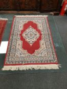 A fringed Iranian rug,