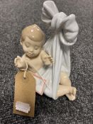 A Lladro figure of a baby boy