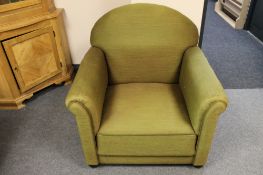 A 1930's armchair in green fabric