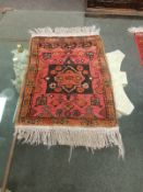 A fringed Afghan rug,