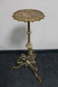 An antique metal tripod plant stand