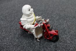 A cast iron figure of Michelin Man on bike