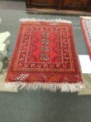 A fringed Afghan rug,