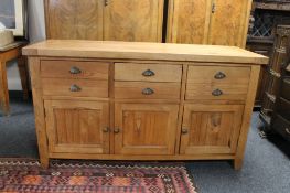 A contemporary oak triple door sideboard