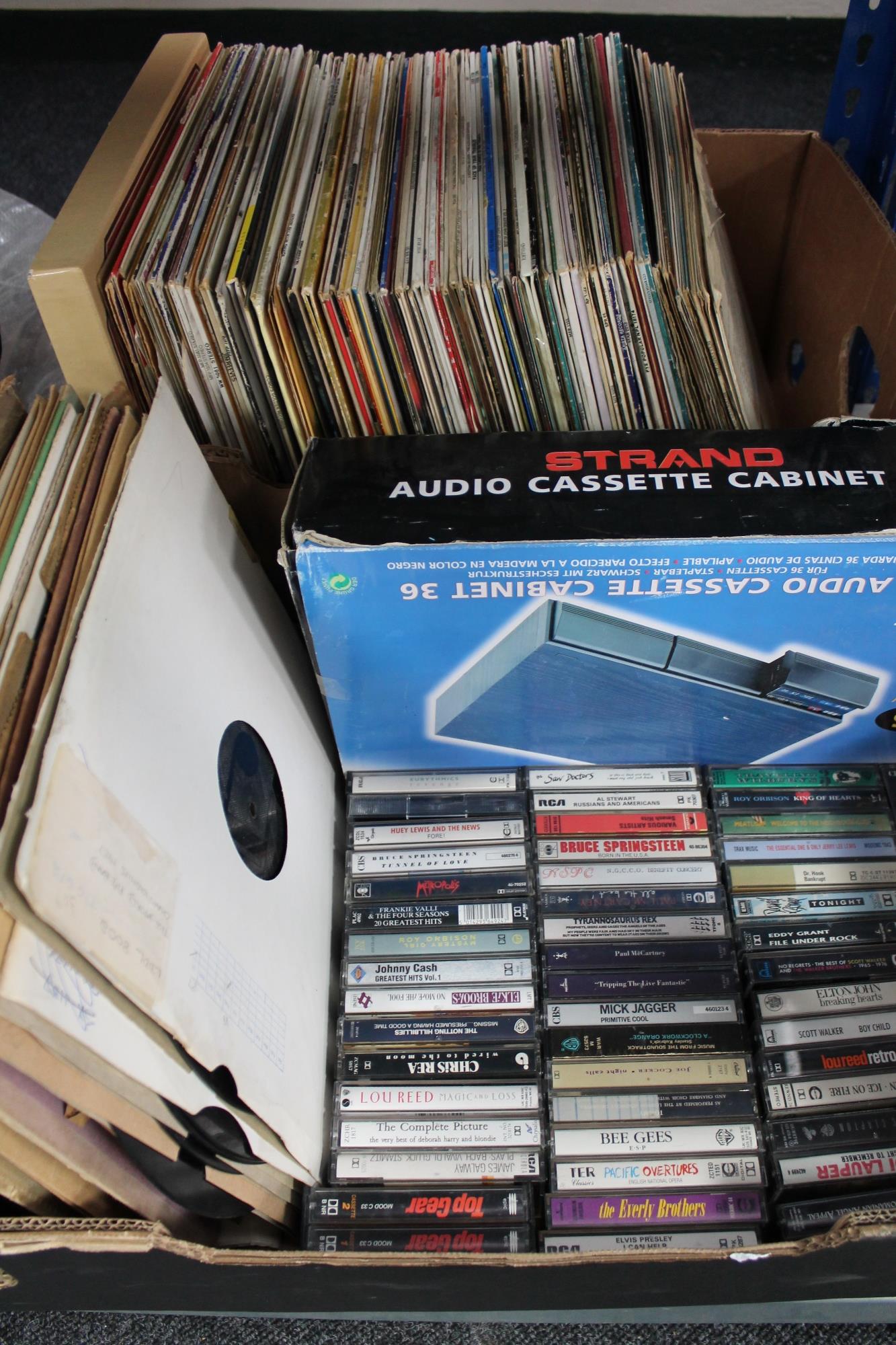 Two boxes of vinyl LP records and cassette tapes,