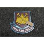 A cast iron plaque - West Ham club crest