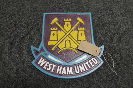 A cast iron plaque - West Ham club crest