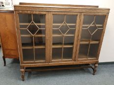 A 1930's oak triple door bookcase,