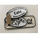 Three cast iron cat signs