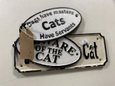 Three cast iron cat signs