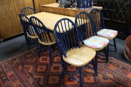 A pine topped kitchen table on painted base and a set of six chairs