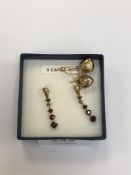 A pair of 9ct gold garnet drop earrings and a pair of 9ct gold heart earrings