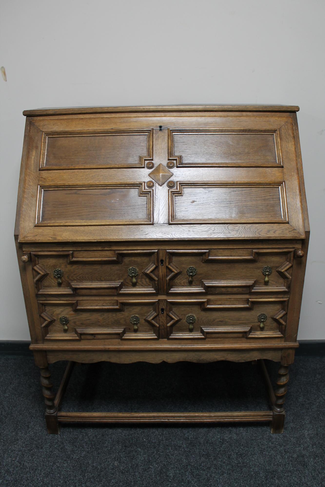 An Edwardian oak bureau on barley twist legs