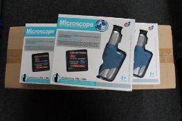 Twenty-one boxed educational microscopes