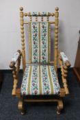 A blonde oak tapestry upholstered rocking chair