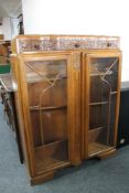 An early 20th century carved oak double door display cabinet