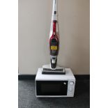 A Morphy Richards electric cordless vacuum cleaner and a microwave