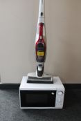 A Morphy Richards electric cordless vacuum cleaner and a microwave