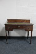 A mahogany Regency style writing desk with green leather inset panel