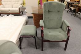 A stained beech framed adjustable armchair and footstool in green fabric