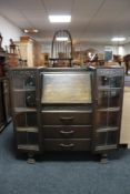 A 1930's oak side by side bureau display cabinet