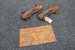 A cast iron railway notice and two cast iron cars