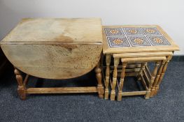 A nest of three blonde oak tiled top tables and a drop leaf coffee table