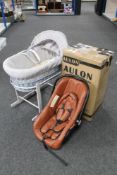 A Moses basket on stand and a boxed Aulon child's car seat