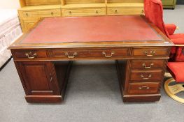 An Edwardian mahogany partner's desk with red leather inset panel