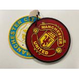 A cast iron plaque - Manchester United and Manchester City