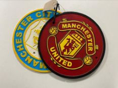 A cast iron plaque - Manchester United and Manchester City
