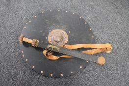 A reproduction wooden handled Norse sword in sheath with circular shield