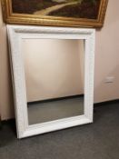 A painted white traditional style mirror,