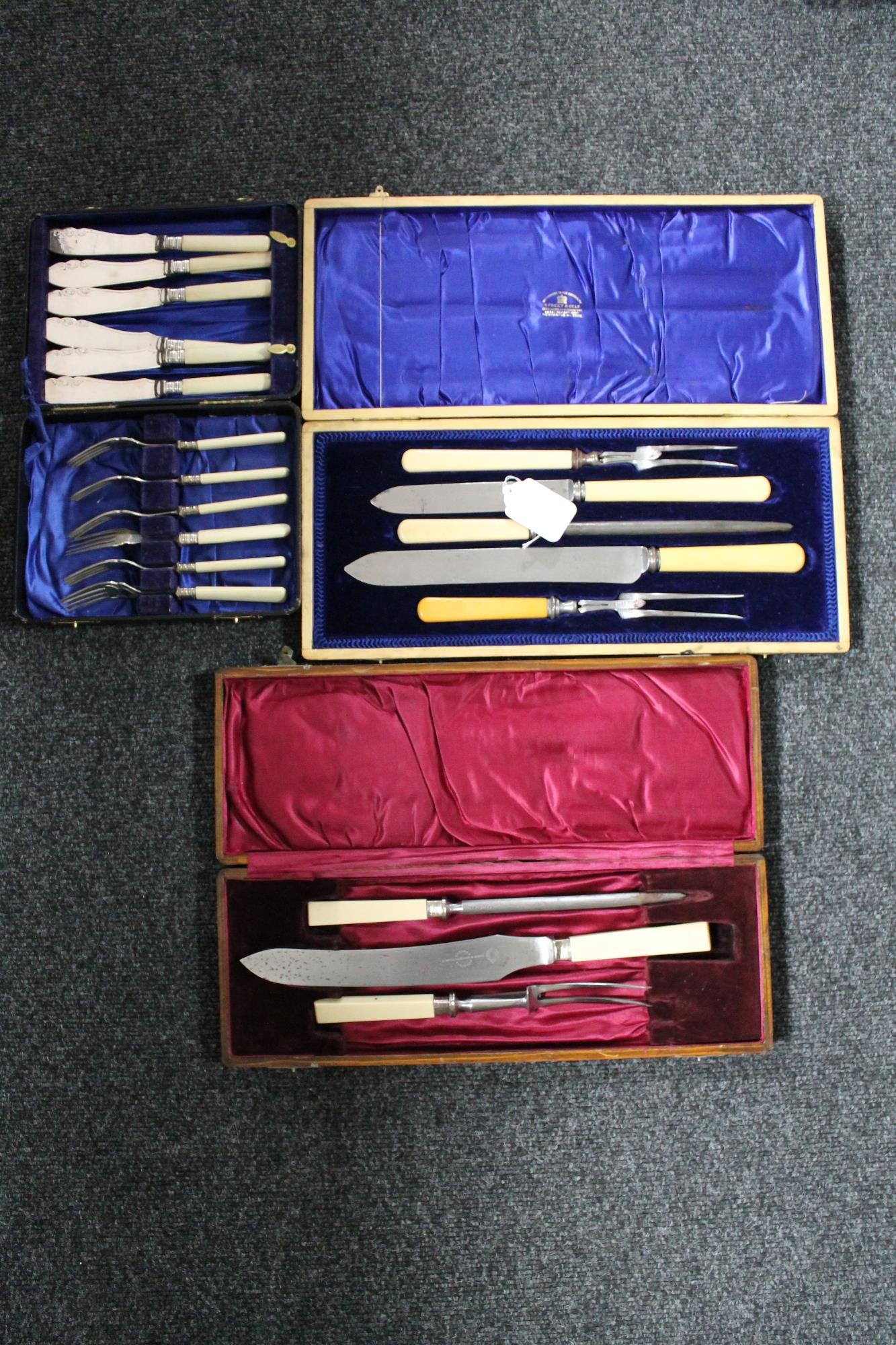 A tray of two cased antique carving sets and a cased canteen of EPNS fish cutlery (3)