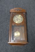 A 20th century oak cased Junghans 8 day wall clock with pendulum and key (glass a/f)