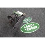 A cast iron Land Rover bracket with bell together with two Land Rover plaques