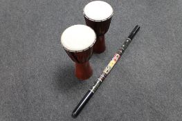 A pair of hand drums and a digeridoo